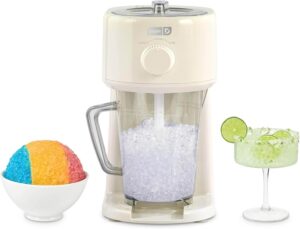 Dash Deluxe cream shaved ice maker with 1L serving pitcher, adjustable blades, and compact design.