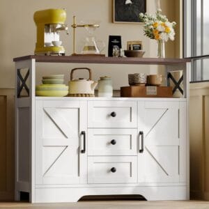 A white farmhouse-style YGEOMER buffet cabinet with barn-style doors, black metal handles, three drawers, two doors, and an open shelf, suitable as a coffee bar or wine station.